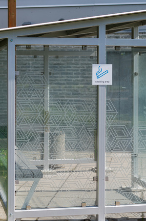 Transparent cabin with sign - smoking areaの写真素材