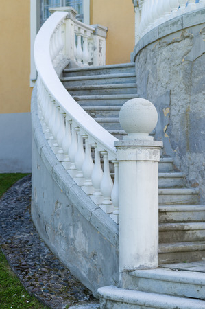 Outdoor old style spiral stairs with column and ornate railingの写真素材