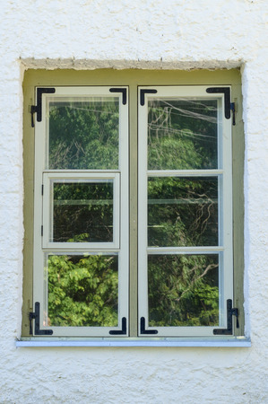 Wooden rural window with tree reflection on mirrorの写真素材
