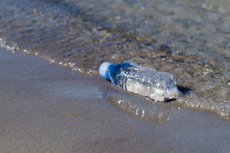 Blurred bottle of fresh water on the seashore, drinking water conceptの写真素材