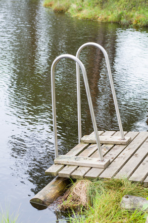 Small wooden jetty with railings to the muskegの写真素材