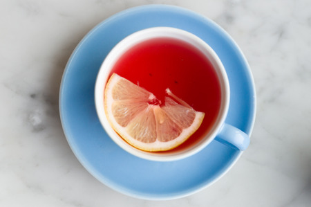 Cup of red fruit tea with lemon slice, top viewの写真素材
