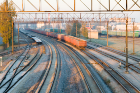 Blurred image of cargo train station on sunrise. Curve platform with containersの写真素材