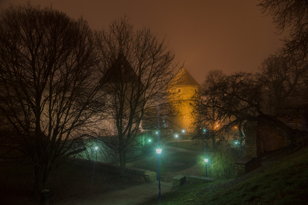 Towers and lanterns of Tallinn old town in night fog, Estoniaのeditorial素材
