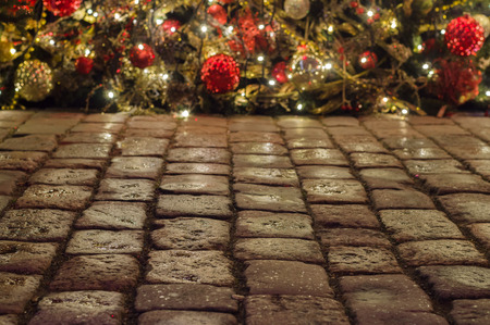 Cobblestone pavement and christmas decorations on backgroundの写真素材