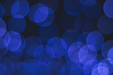 Abstract background of blue bokeh lights layered one another