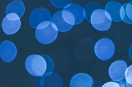 Abstract background of blue blurred lights with bokeh effectの写真素材