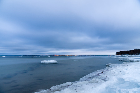 Freezing seashore in the dusk, winter-time landscapeの写真素材