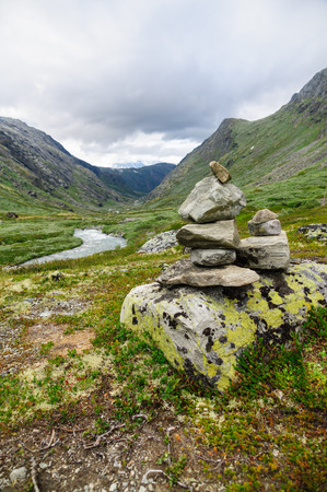 Stack of stones in front of valleyの写真素材