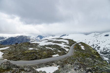 New highland road built in snowy mountains of Norwayの写真素材