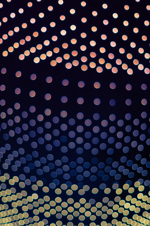 Dark background of gradient bokeh lightsの写真素材