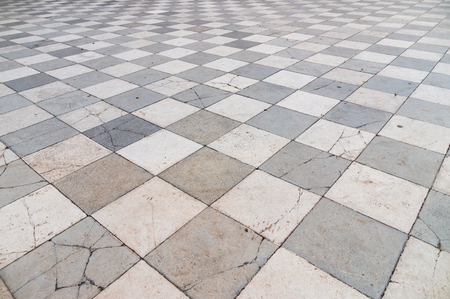 Old and partly cracked tiled floor, wide angle perspective viewの写真素材