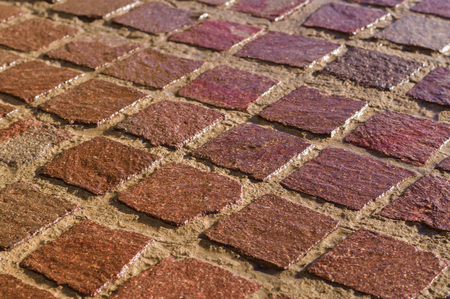 Decorative square tiled ground, wet after rain, shallow depth of fieldの写真素材