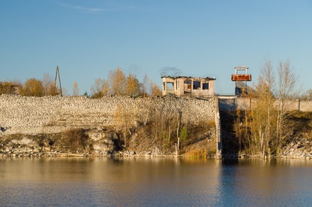Abandoned prison barbed wire wall and watch tower