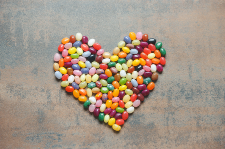 Heart symbol from jelly beans on dark background, love conceptの写真素材