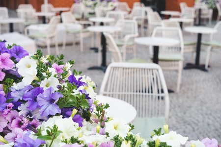 Colorful street petunia flowers in front of intimate outdoor restaurantの写真素材