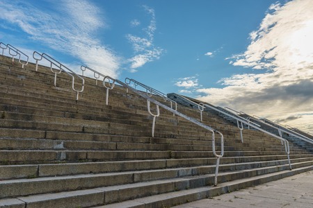 Wide old outdoor concrete staircase against scenic cloudscapeの写真素材