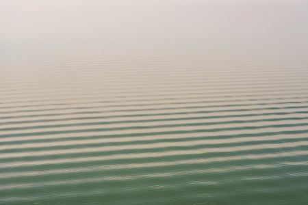 Abstract seascape background. Calm open sea with ripple on water surface