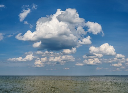 Open sea panorama with blue sky and scenic fluffy cloudsの写真素材