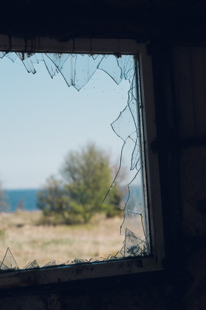 View through window with broken glass. Decay conceptの写真素材