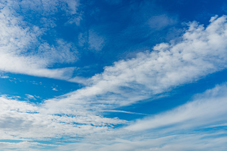 Wonderful altocumulus clouds on blue sky, natural backgroundの写真素材