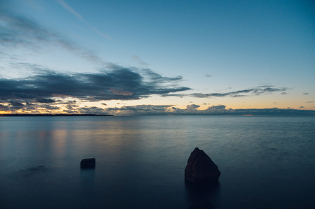 Stone silhouettes against wonderful sunset, long exposure imageの写真素材