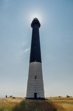 Sorve lighthouse against sun, Saaremaa island, Estoniaの写真素材