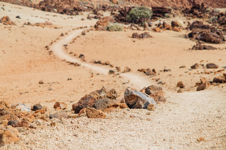 Volcanic rocks, winding hiking trail on background, Tenerife island, Spainの写真素材
