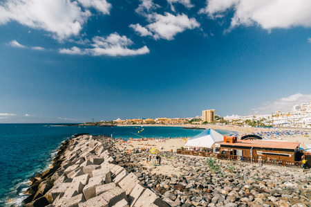 LOS CRISTIANOS, SPAIN - JANUARY 19, 2016: Crowd of tourists enjoying sunny weather on the picturesque Playa de Las Vistas beach.のeditorial素材