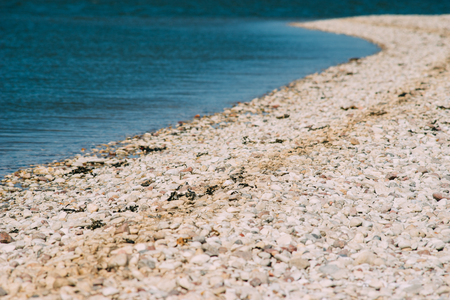 Wild stony seacoast on a sunny day. Selective focusの写真素材