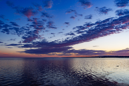 Dramatic summer sunrise over Baltic sea, scenic cloudsの写真素材