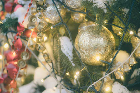 Decorated and illuminated christmas tree with natural snow. Selective focus, toned imageの写真素材