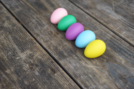 Row of colorful eggs on wooden table. Happy easter backgroundの写真素材