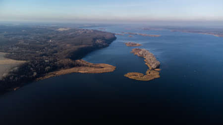 Beautiful autumn nature landscape. Flying above river, swamps, mixed forest, yellow regular trees....