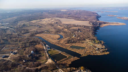 Aerial video footage with a view of the autumn landscape, river andfield.
