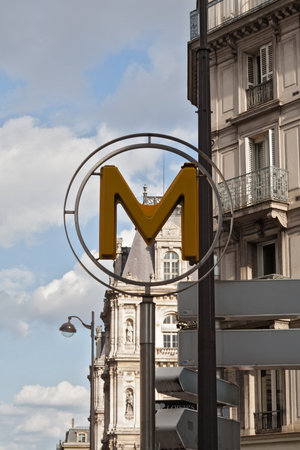 Subway, Metro sign in Paris with city buildingsのeditorial素材