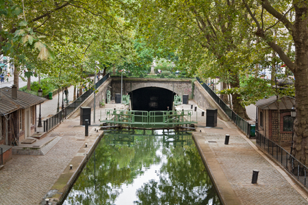 Canal Saint Martin in Paris with sluice and bridgeの写真素材