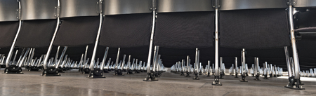 Rows of empty black modern chairs in a roomの写真素材