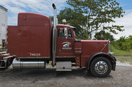 A red truck parked at the edge of the road in Guabito, Panama.のeditorial素材