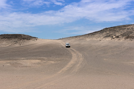 car on a sand road in the mondlandschaft east of swakopmund, namibia.のeditorial素材