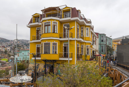 Beautiful traditional yellow wooden building in Valparaiso, Chileのeditorial素材