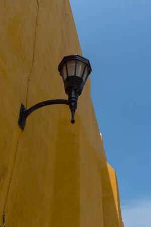 Street lamp on a yellow house wall in Campeche, Mexicoの写真素材