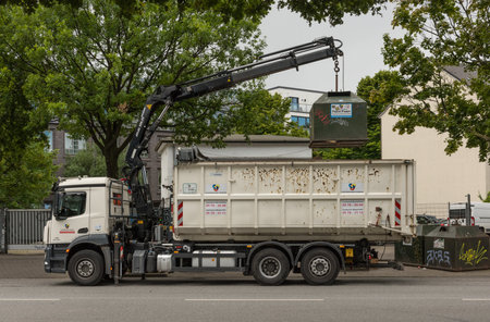 a truck empties a waste paper container in Hamburg, Germany