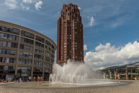 Children play in the water flows from the fountain in front of the Main Plaza Tower, Frankfurt, Germanyのeditorial素材