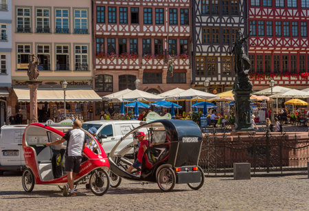 Rickshaw drivers with their vehicles on the Roemerberg waiting for passengers for a city tour, Frankfurt, Germanyのeditorial素材