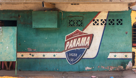 weathered beer advertising on the wall of an old building in Panama Cityのeditorial素材