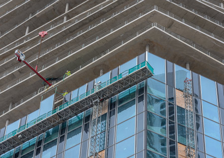 Workers inserting windows on a high-rise building, Frankfurt am Main, Germany