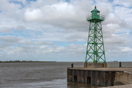 Small green lighthouse at the mouth of the Geeste River in the North Sea, Bremerhavenの写真素材