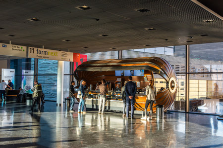 Unknown people in front of a snack stand at a trade fair in Frankfurt, Germanyのeditorial素材