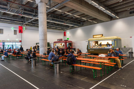 Unknown people in front of a snack stand at a trade fair in Frankfurt, Germanyのeditorial素材